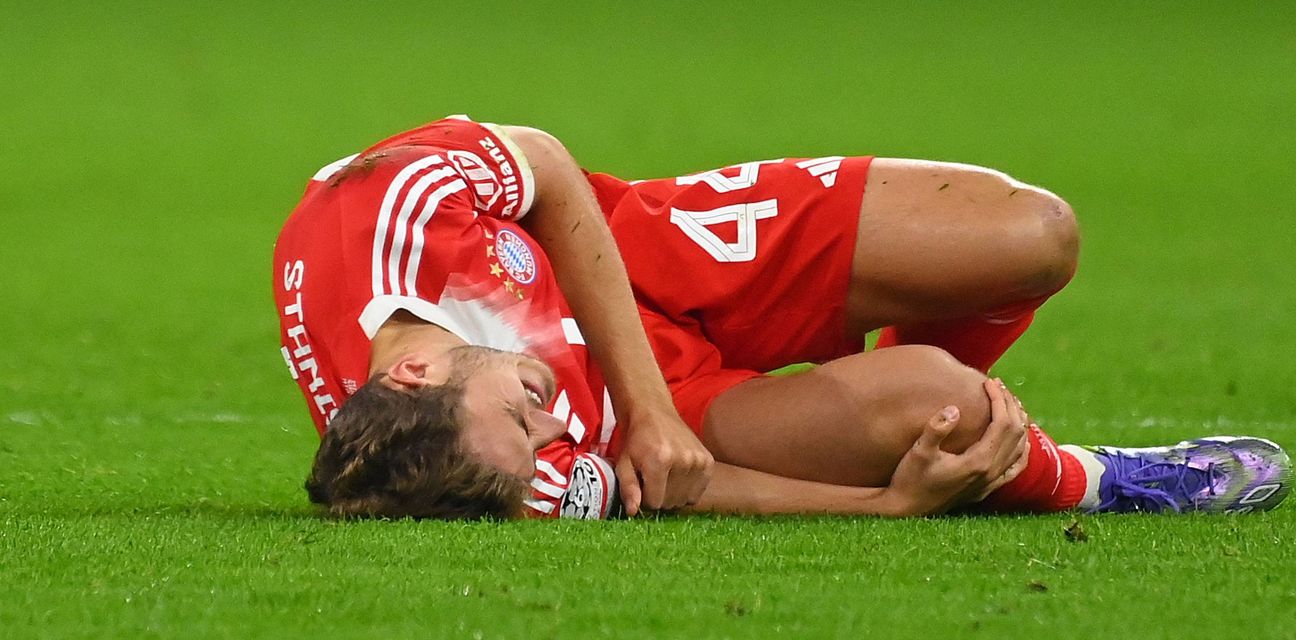 Bayern Munich defender Josip Stanisic laying injured on the field