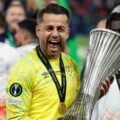 Lukasz Fabianski holding the Europa Conference League trophy