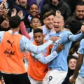 Manchester City players celebrate after scoring against city rivals United