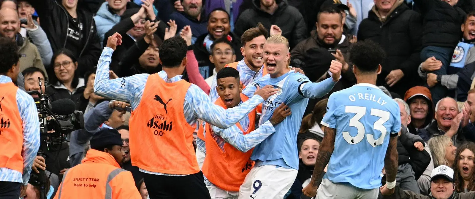Manchester City players celebrate after scoring against city rivals United