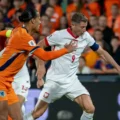 Virgil Van Dijk trying to stop Robert Lewandowski during the 2026 World Cup qualifier between the Netherlands and Poland