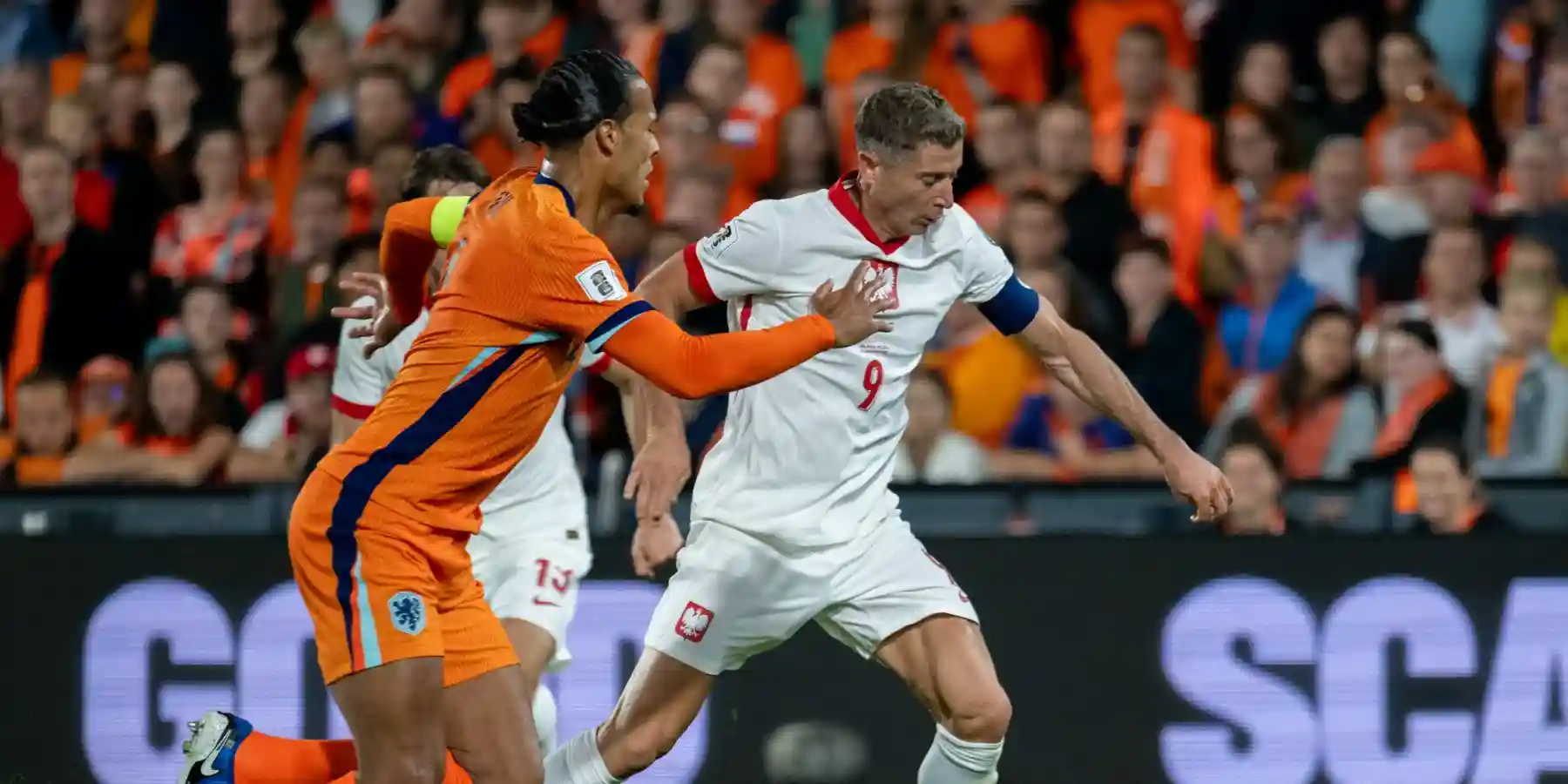 Virgil Van Dijk trying to stop Robert Lewandowski during the 2026 World Cup qualifier between the Netherlands and Poland