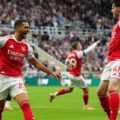 Arsenal players celebrate after scoring late against Newcastle