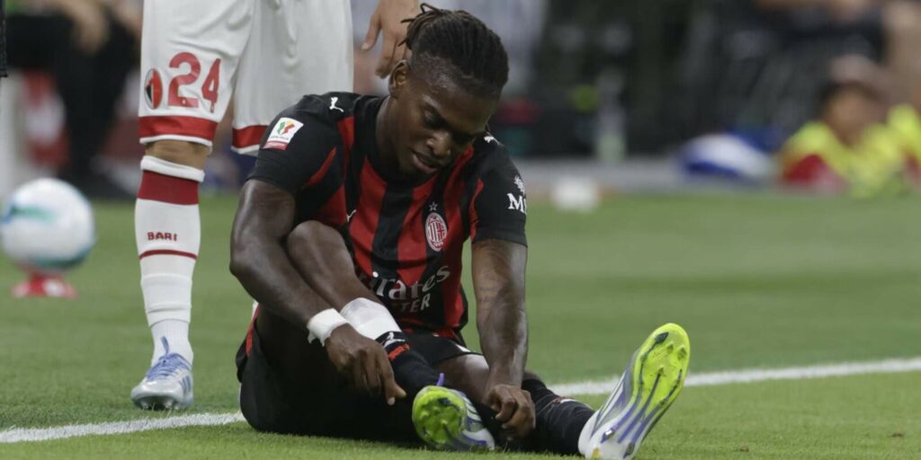 Rafael Leao sitting on the ground injured