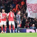 Arsenal players congratulate one another after opening the score against Olympiacos