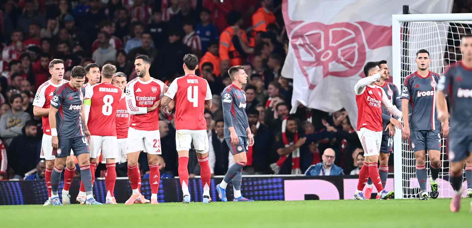 Arsenal players congratulate one another after opening the score against Olympiacos