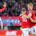 Austria players congratulate one another after scoring against San Marino