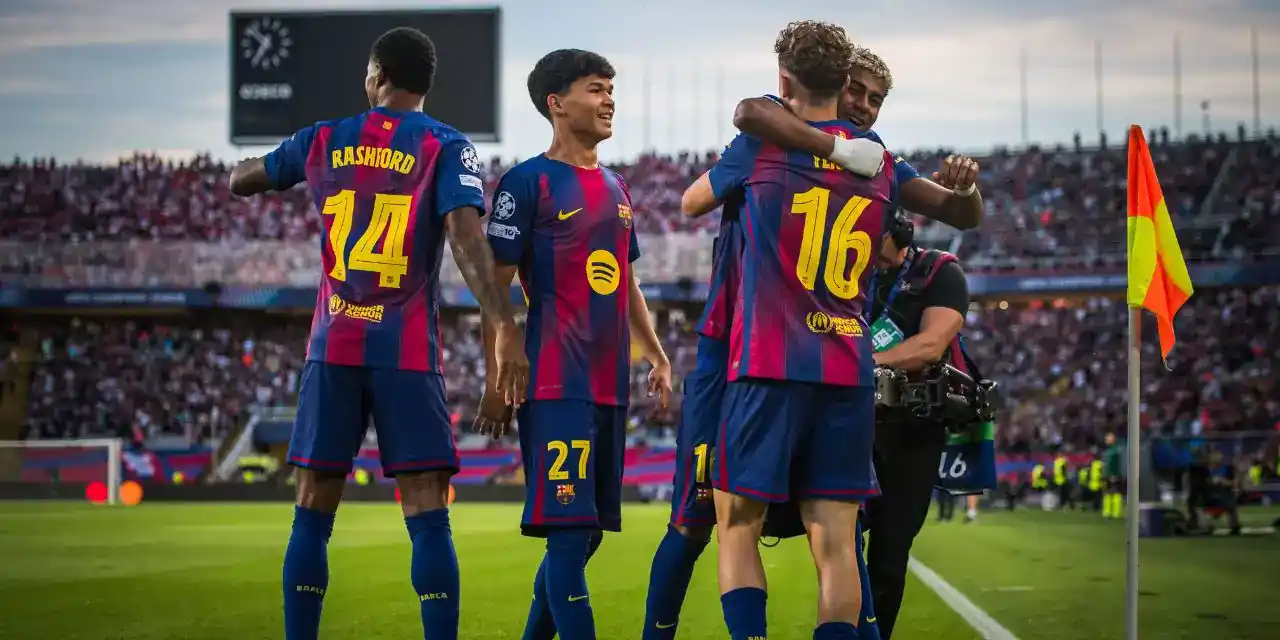 Barcelona players celebrate after scoring against Olympiacos