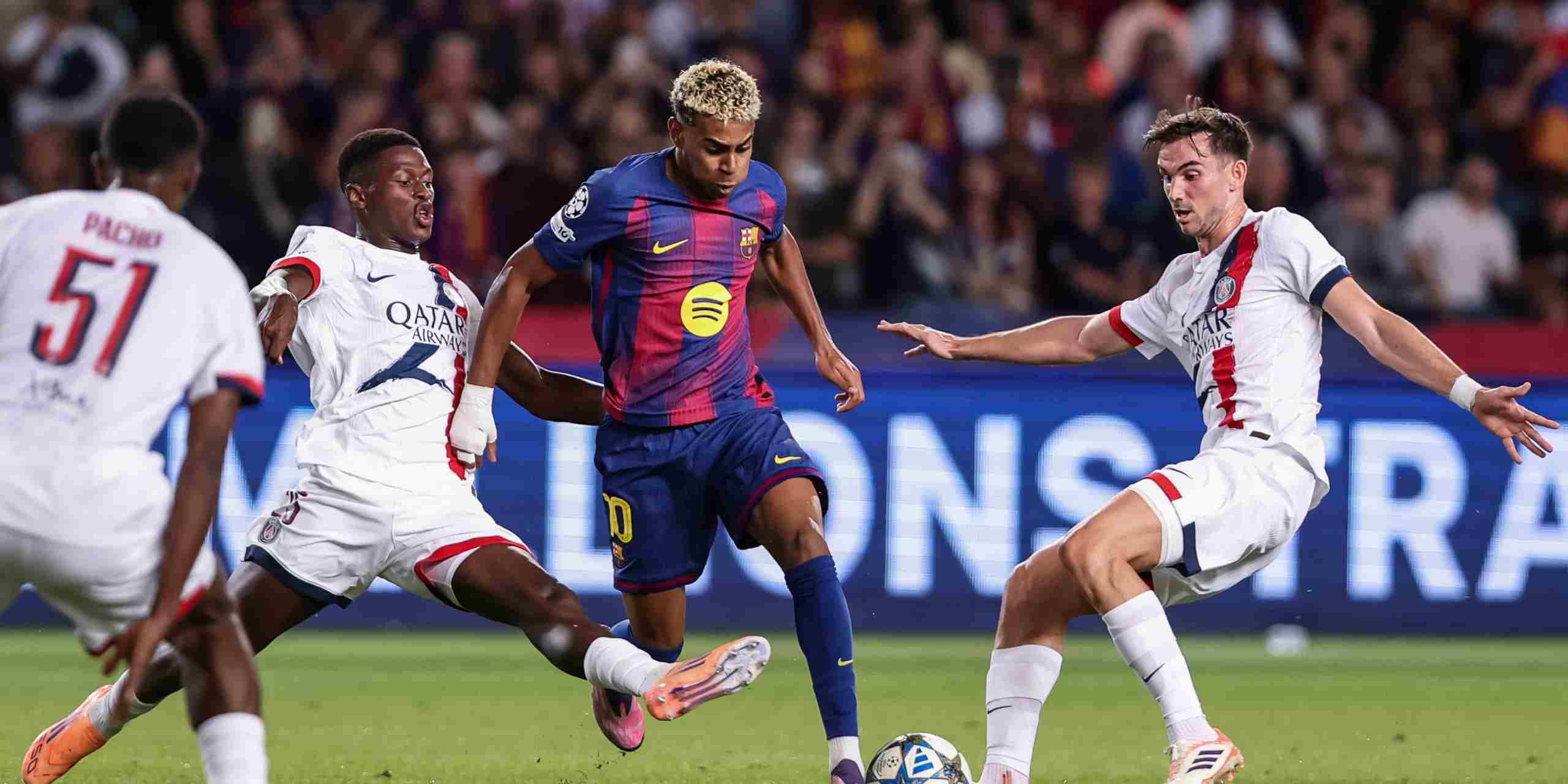 Lamine Yamal dribbles the ball between PSG players