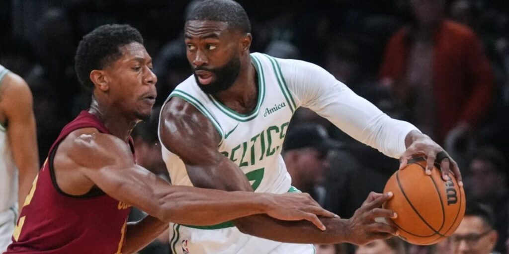 Jaylen Brown protecting the ball from a Cleveland opponent