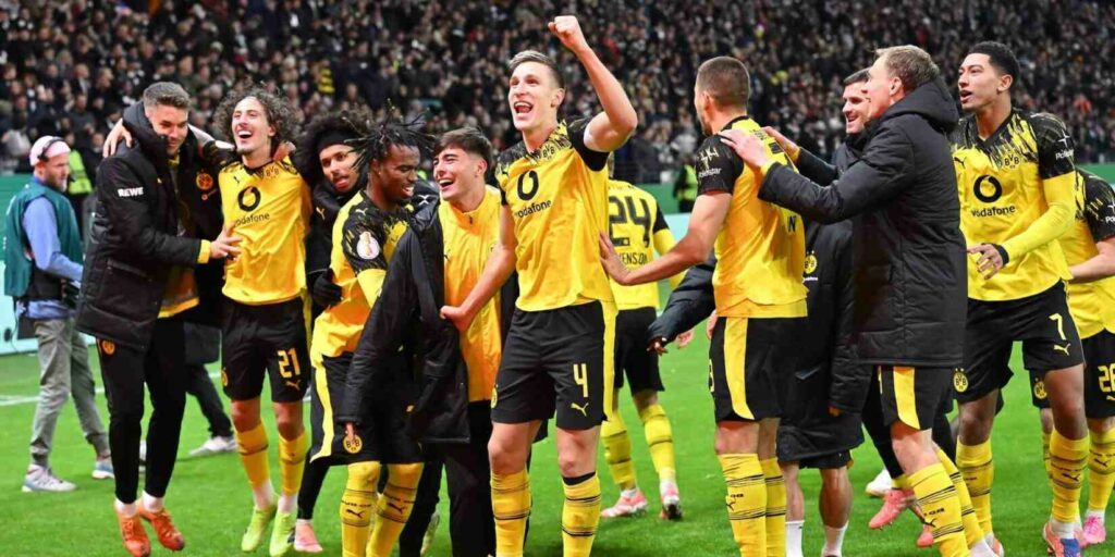 Borussia Dortmund players celebrate after eliminating Eintracht Frankfurt on penalties