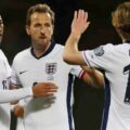 England players congratulate one another after scoring against Latvia