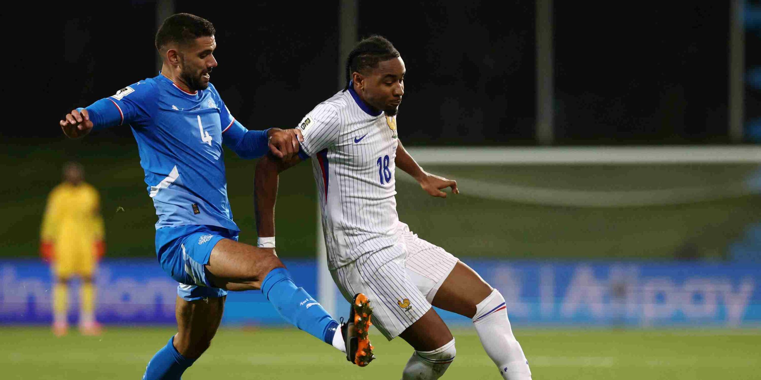 Christopher Nkunku protecting the ball from an Iceland player