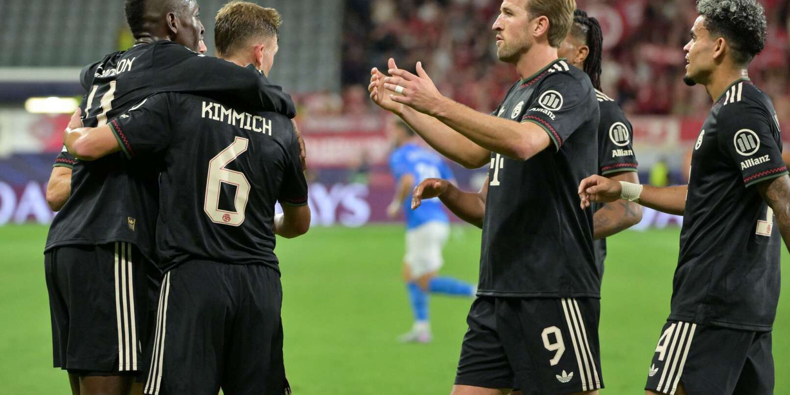 Bayern Munich players rushing to congratulate Nico Jackson for his first goal