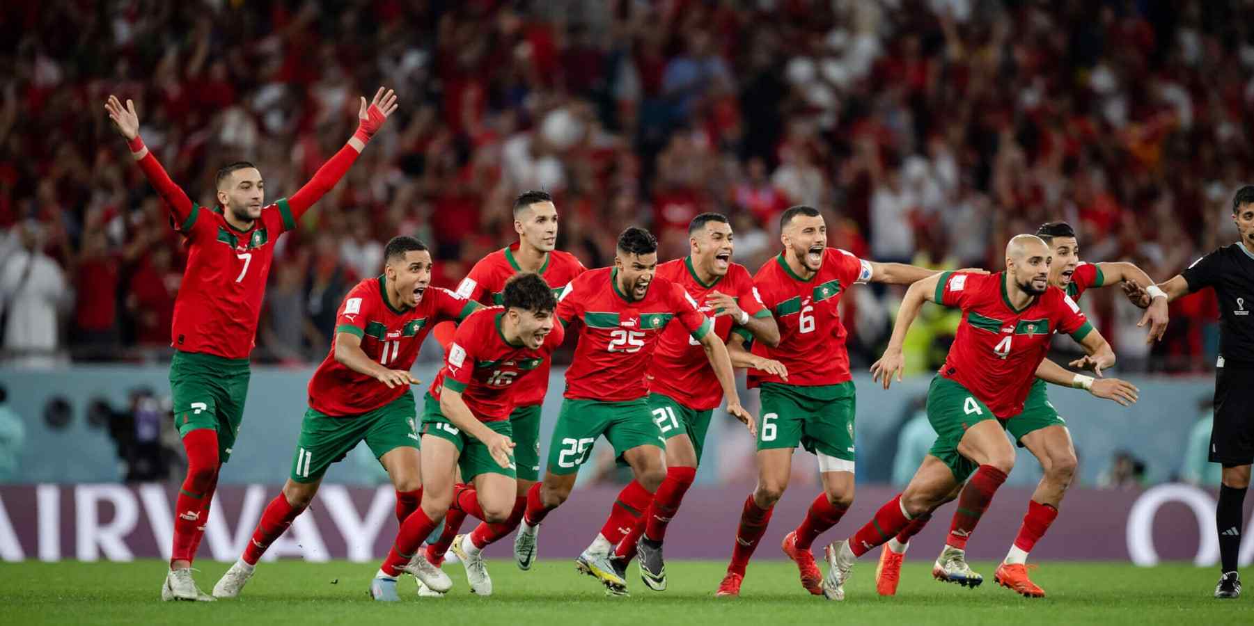 Morocco players rush to celebrate after winning on penalties