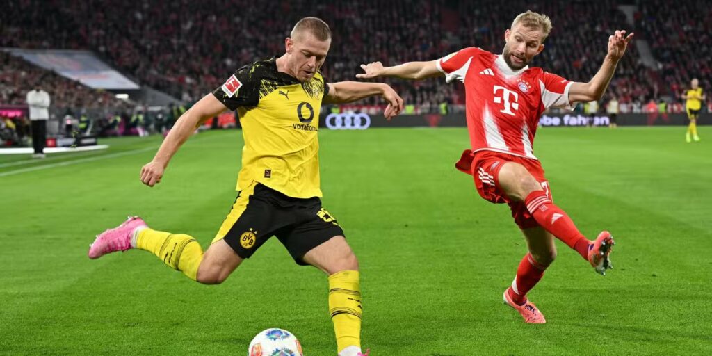 Niklas Sule ready to cross the ball in a match against Bayern Munich