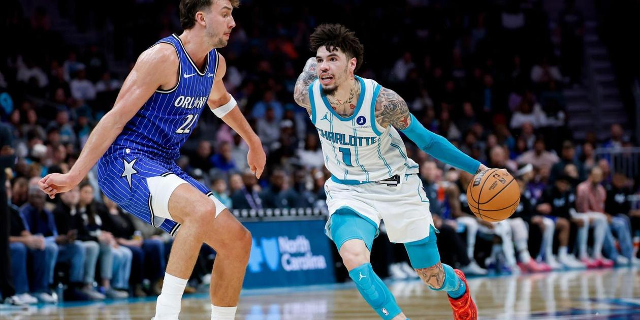 LaMelo Ball dribbles the ball guarded by Franz Wagner