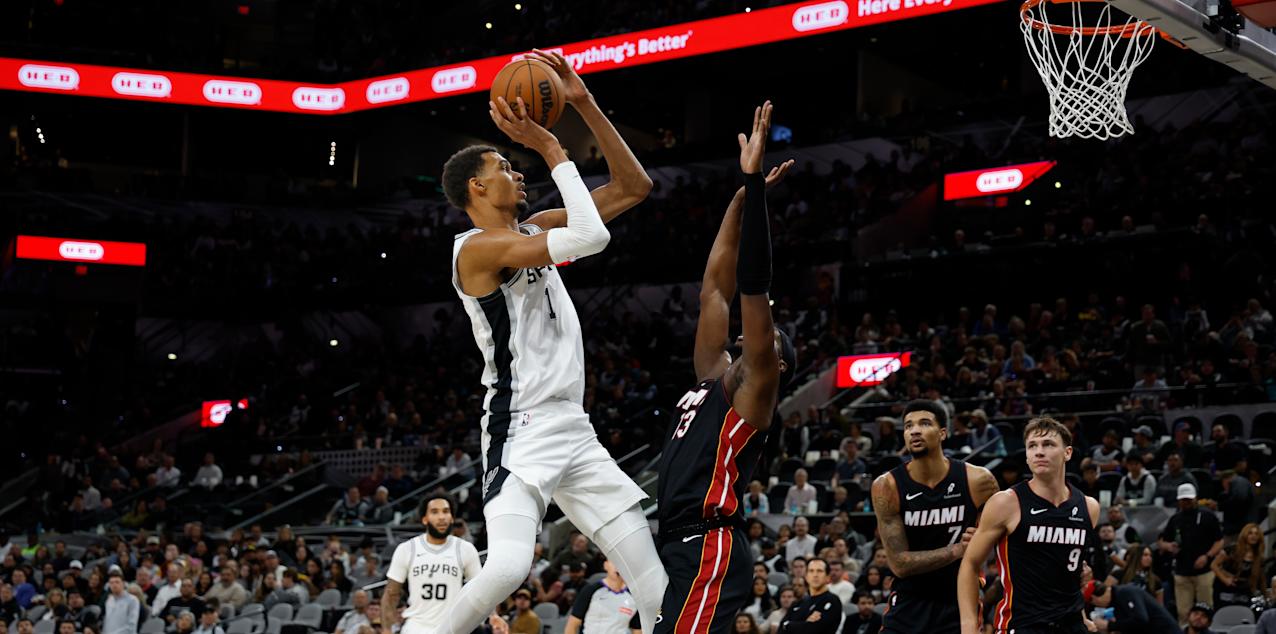 Victor Wembanyama shoots at the basket, guarded by Bam Adebayo
