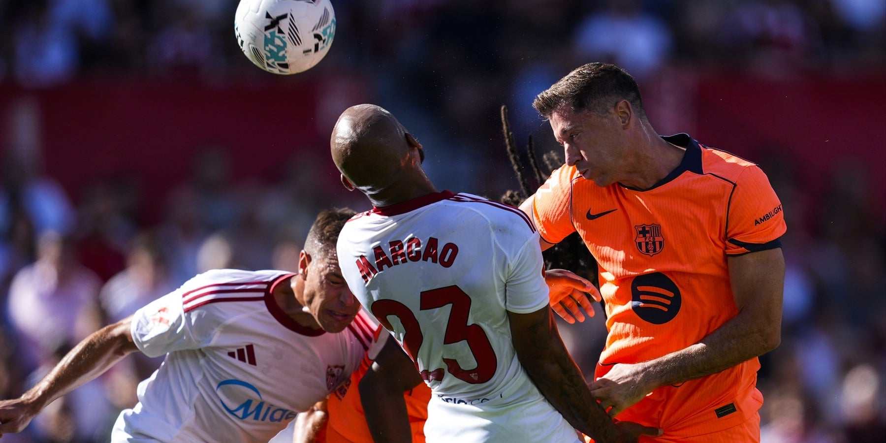 Robert Lewandowski and Marcao in a duel for a high ball
