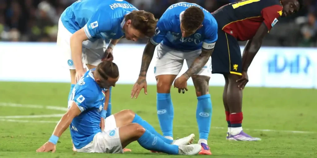 Napoli player Stanislav Lobotka sitting on the ground injured