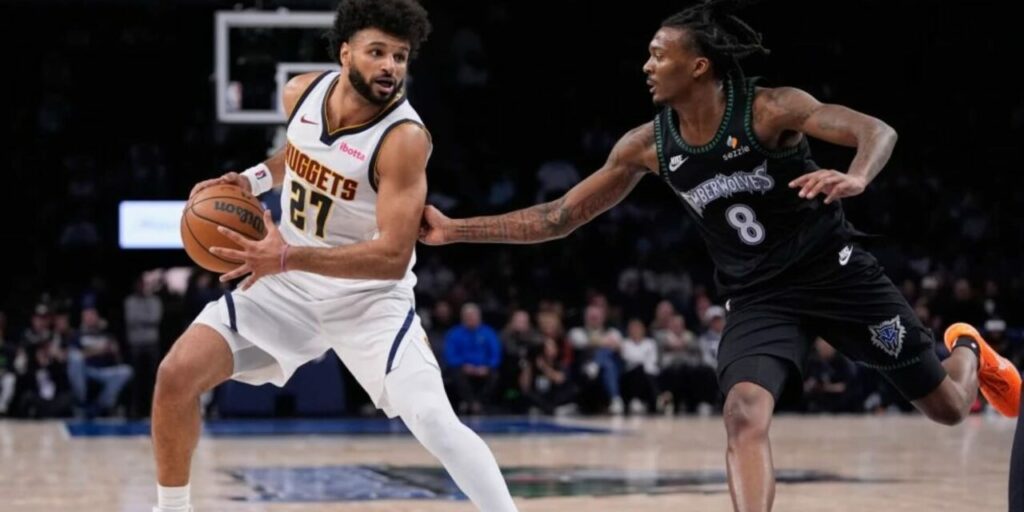 Denver's guard Jamal Murray guarded by a Minnesota player