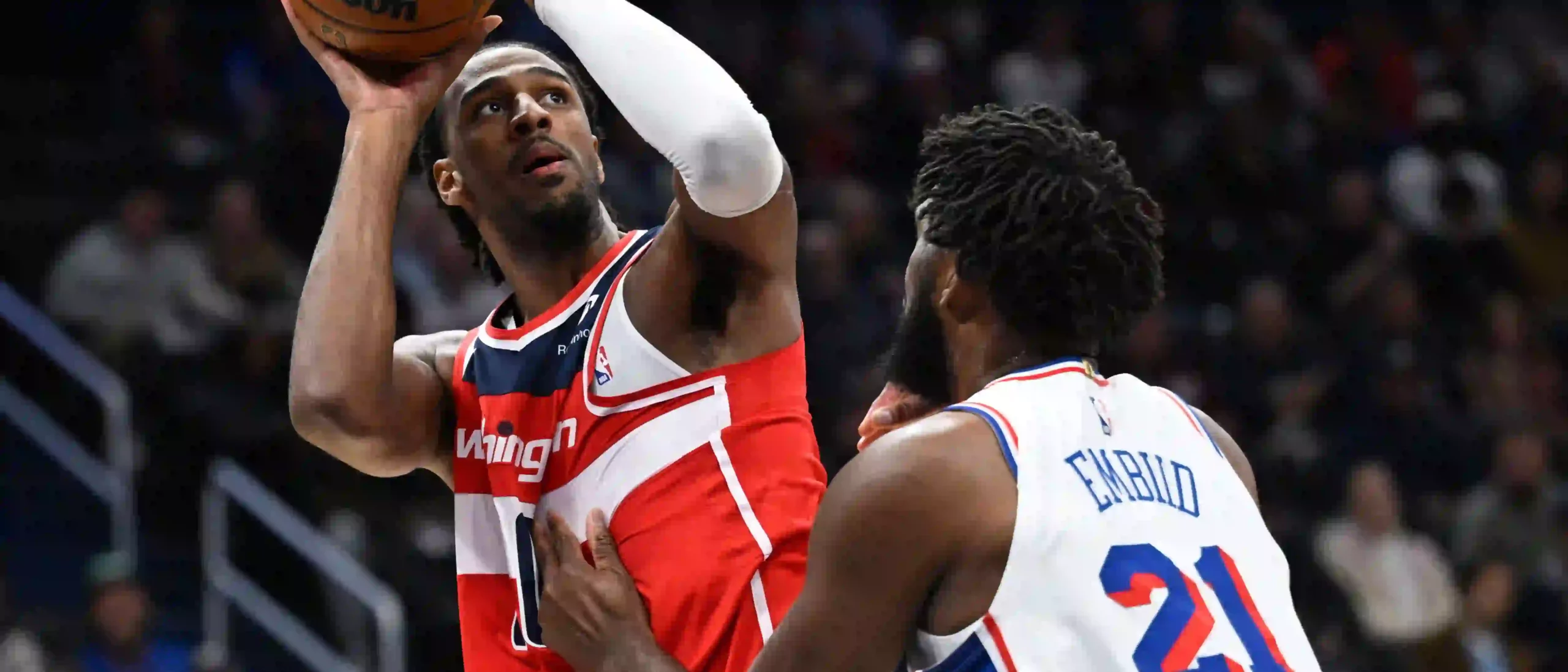 Alex Sarr shoots over Joel Embiid