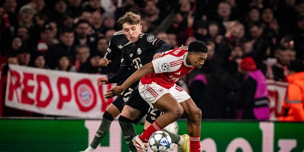 Lennart Karl and Myles Lewis-Skelly in a battle for the ball