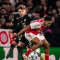 Lennart Karl and Myles Lewis-Skelly in a battle for the ball