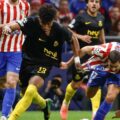 Union SG player tries to escape a challenge from Atletico Madrid footballer