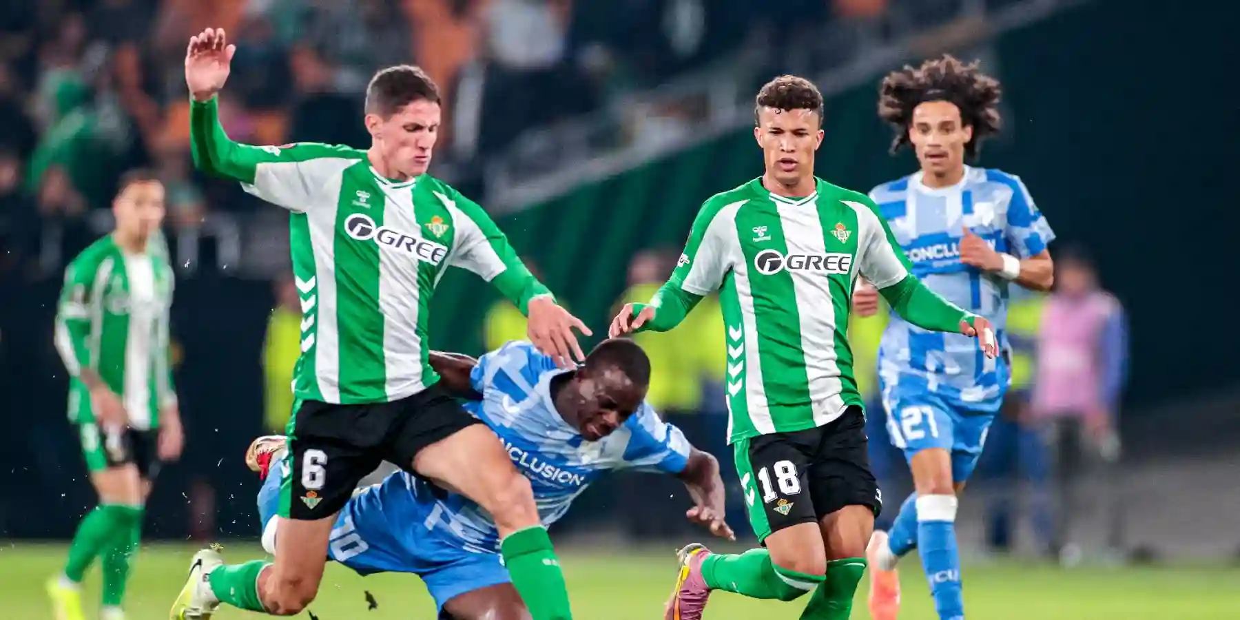 Betis and Utrecht players in a battle for the ball