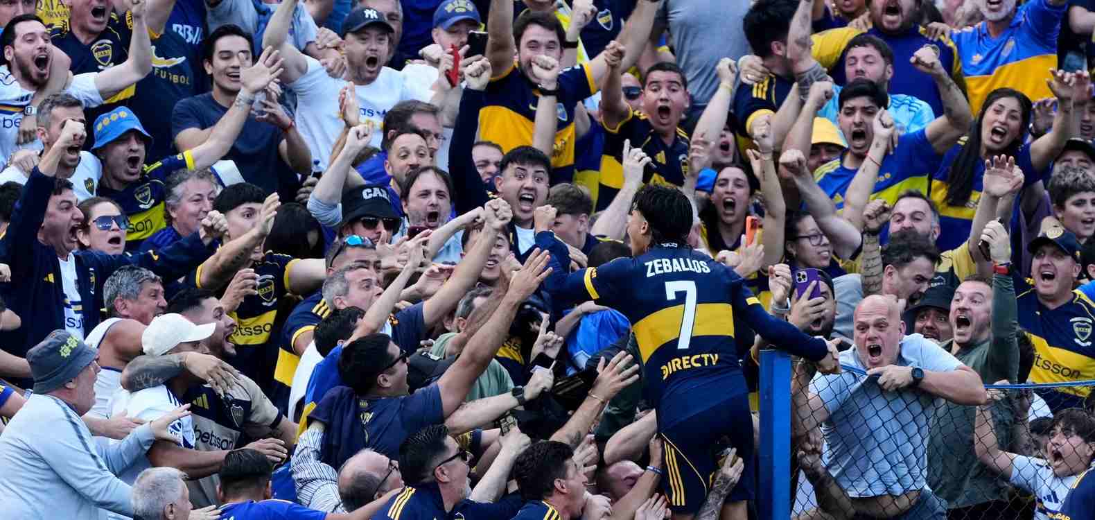 Exequiel Zeballos celebrates with the fans after scoring against River Plate