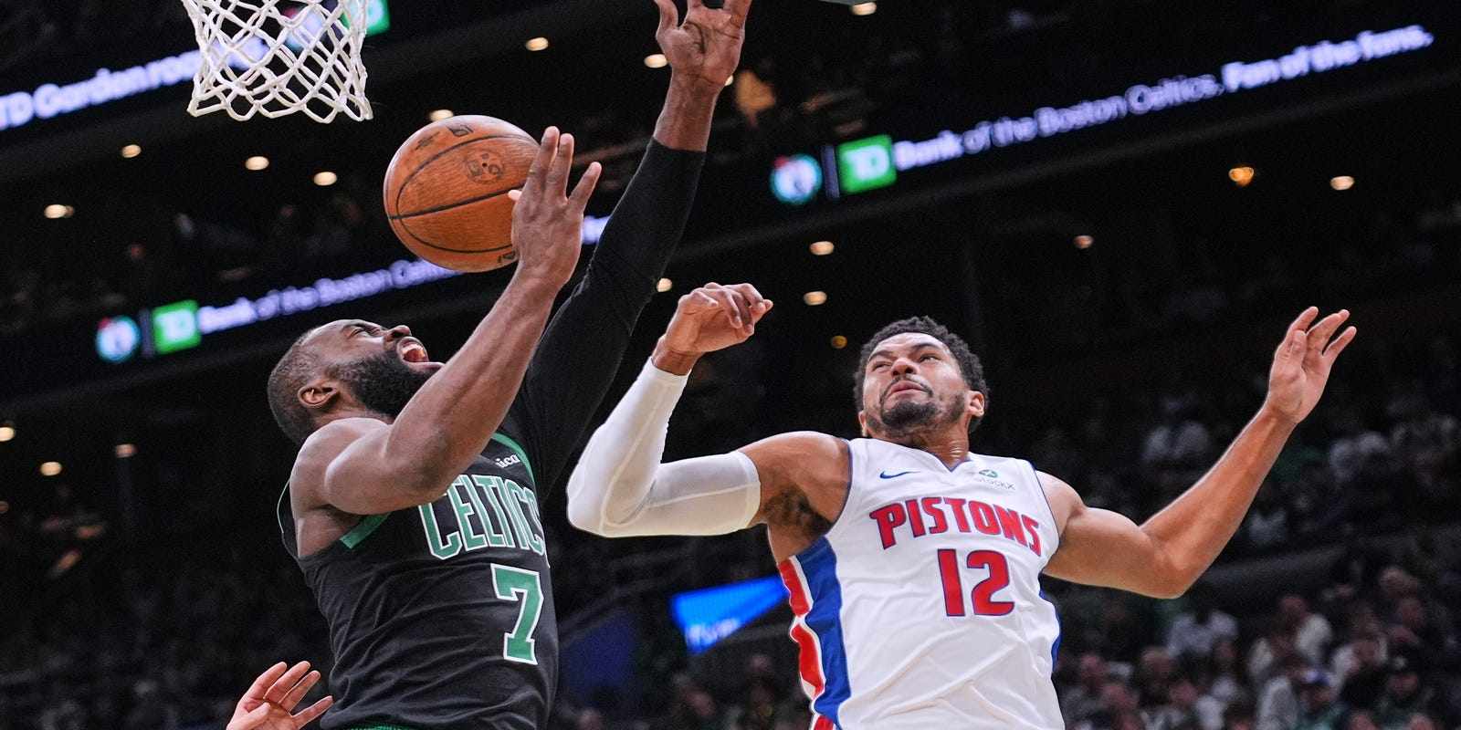 Jaylen Brown attempts to lay the ball up in Detroit Pistons basket