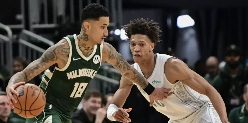 Kyle Kuzma guarded by Kessler Edwards