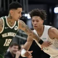 Kyle Kuzma guarded by Kessler Edwards