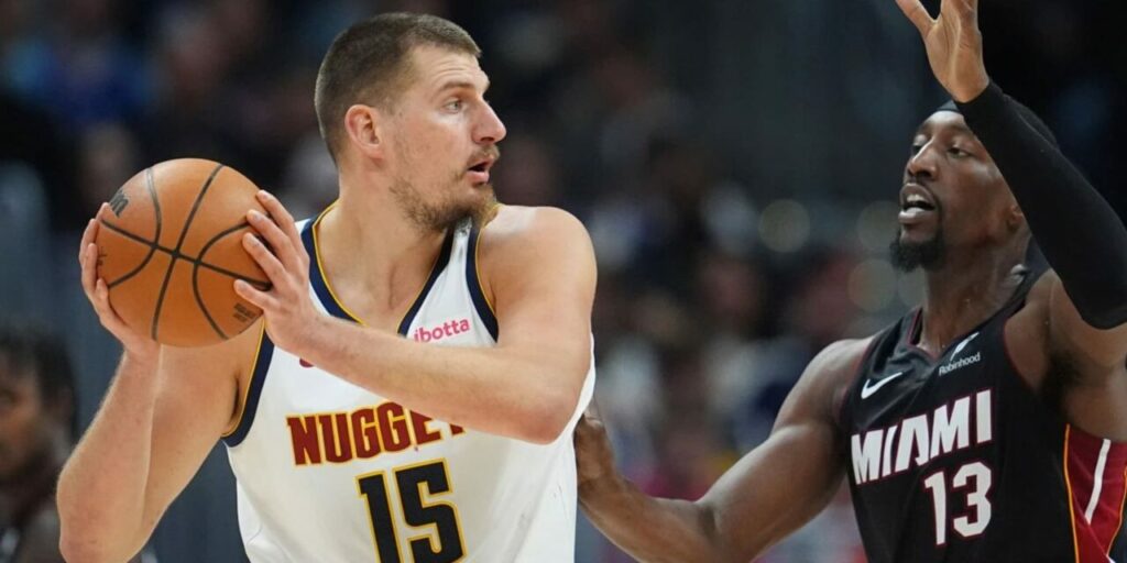 Nikola Jokic guarded by Bam Adebayo
