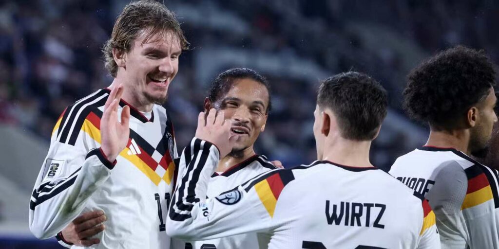 Nick Woltemade, Leroy Sane, and Florian Wirtz celebrate Germany's goal against Slovakia