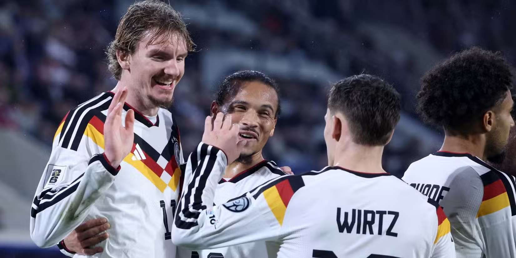 Nick Woltemade, Leroy Sane, and Florian Wirtz celebrate Germany's goal against Slovakia