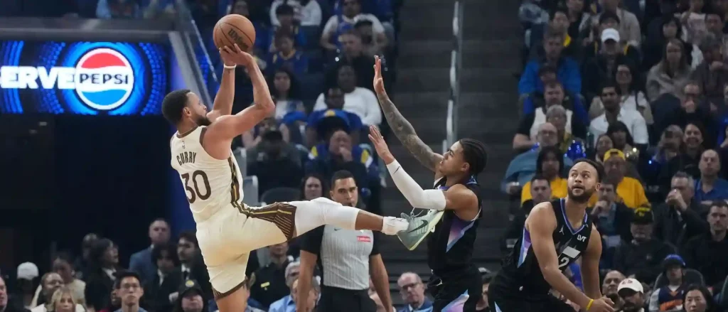 Steph Curry shoots at Utah Jazz' basket