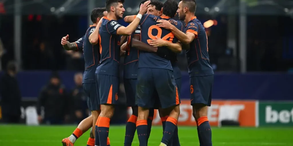 Inter players gathered in a circle celebrating goal against Kairat
