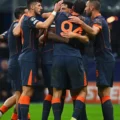 Inter players gathered in a circle celebrating goal against Kairat