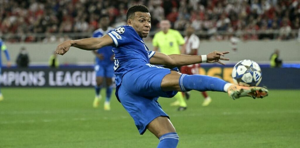 Kylian Mbappe shoots towards Olympiacos' goal
