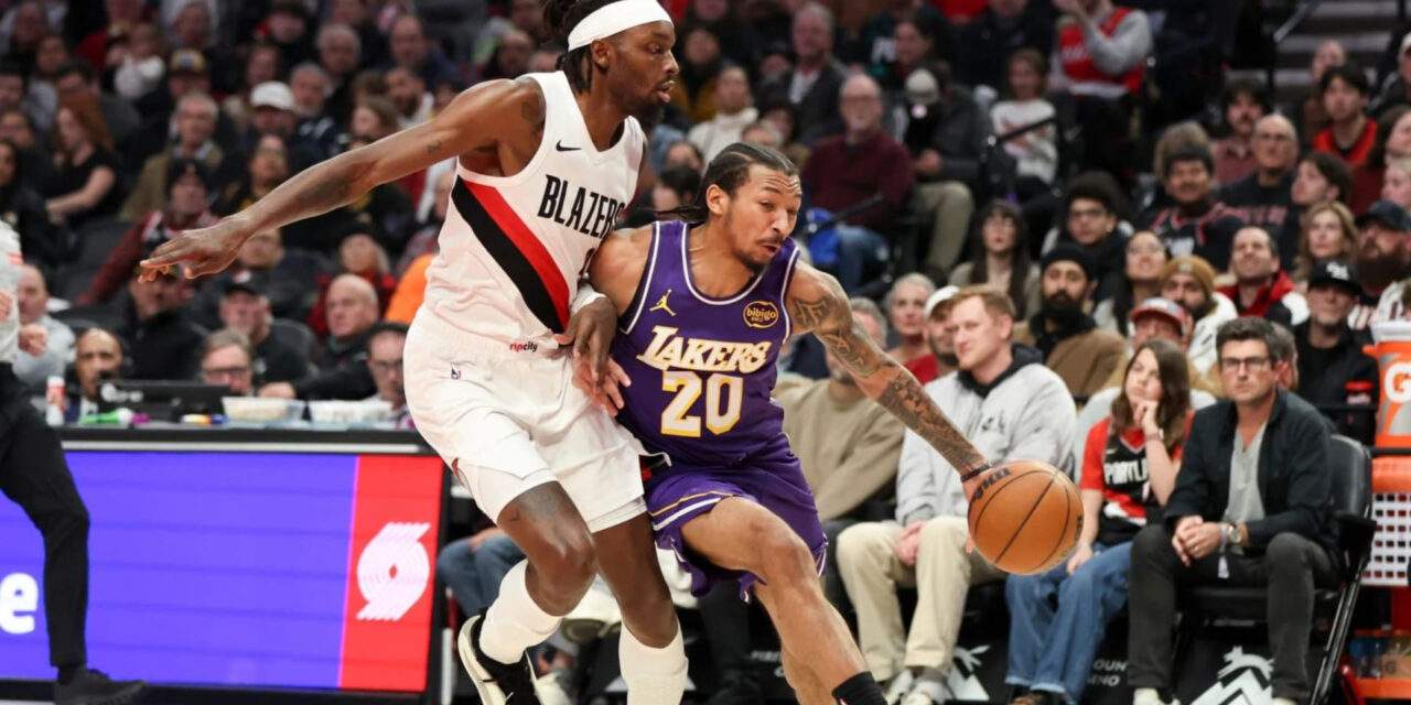 Nick Smith Jr. dribbles the ball guarded by Portland Trail Brazlers' player