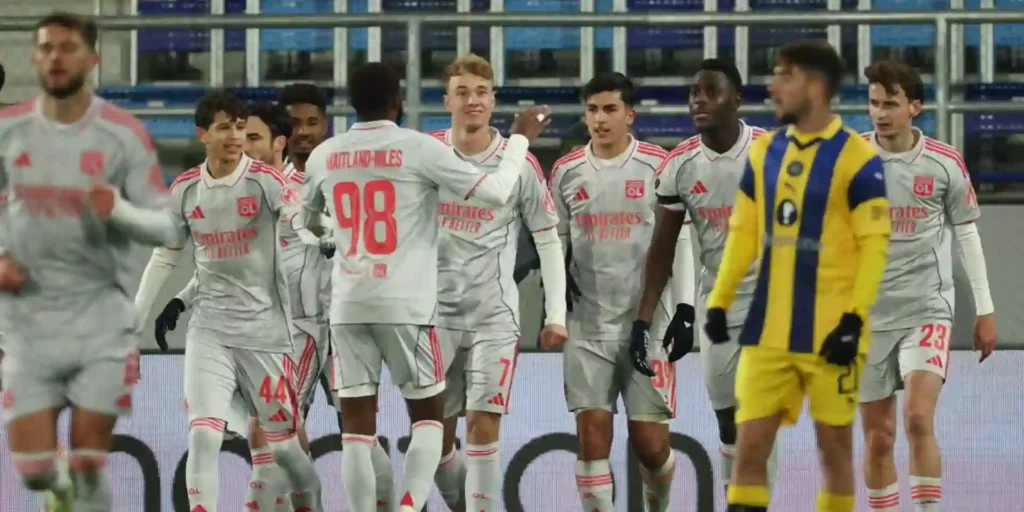 Lyon players celebrate after scoring against Maccabi Tel Aviv