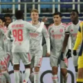 Lyon players celebrate after scoring against Maccabi Tel Aviv