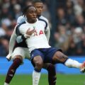 Tottenham striker Mathys Tel protecting the ball from an opposition player
