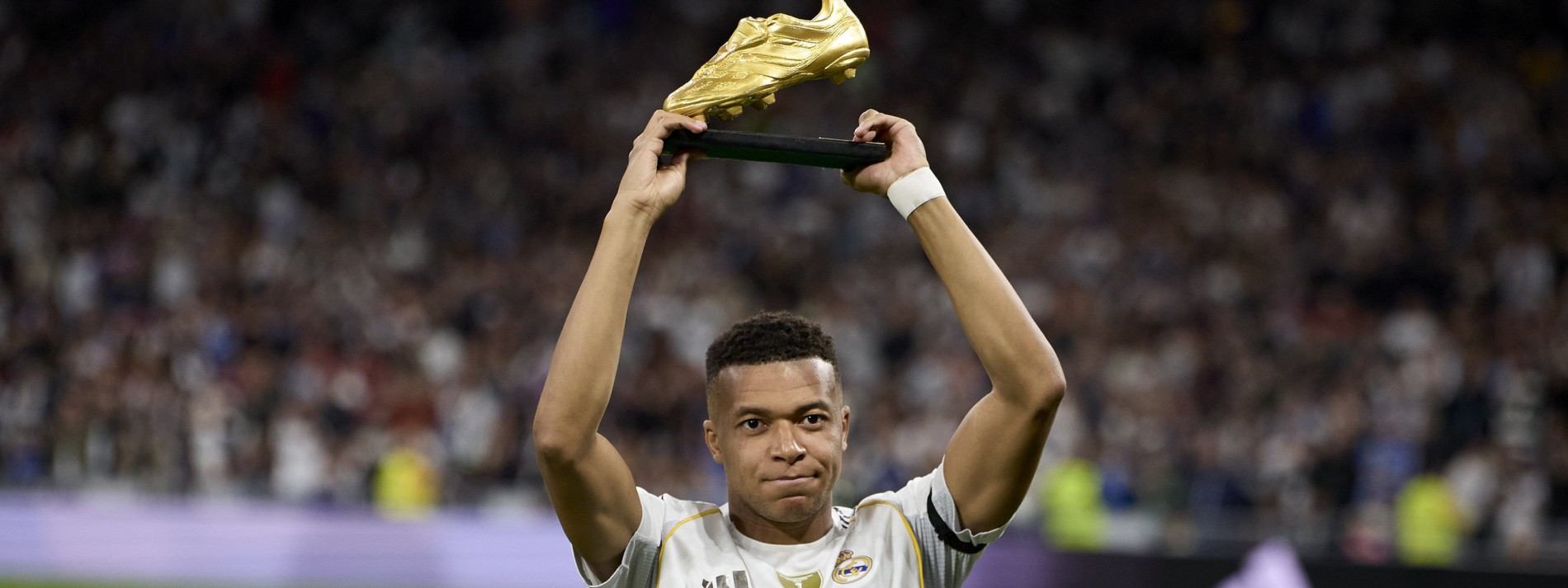 Kylian Mbappe posing with his Golden Boot trophy for the 2024/25 season