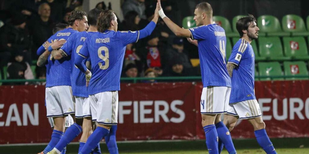 Italy players congratulate one another after scoring against Moldova
