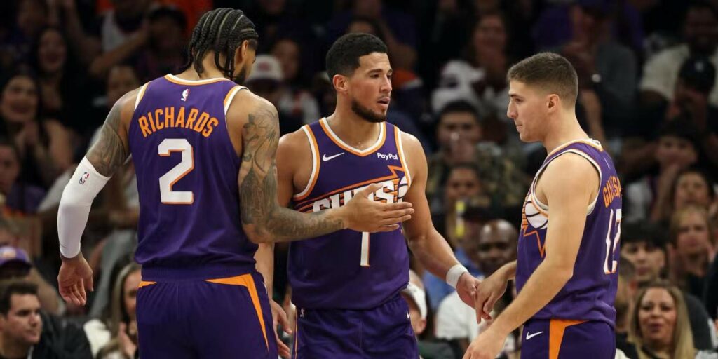 Nick Richards and Collin Gillespie congratulate Devin Booker