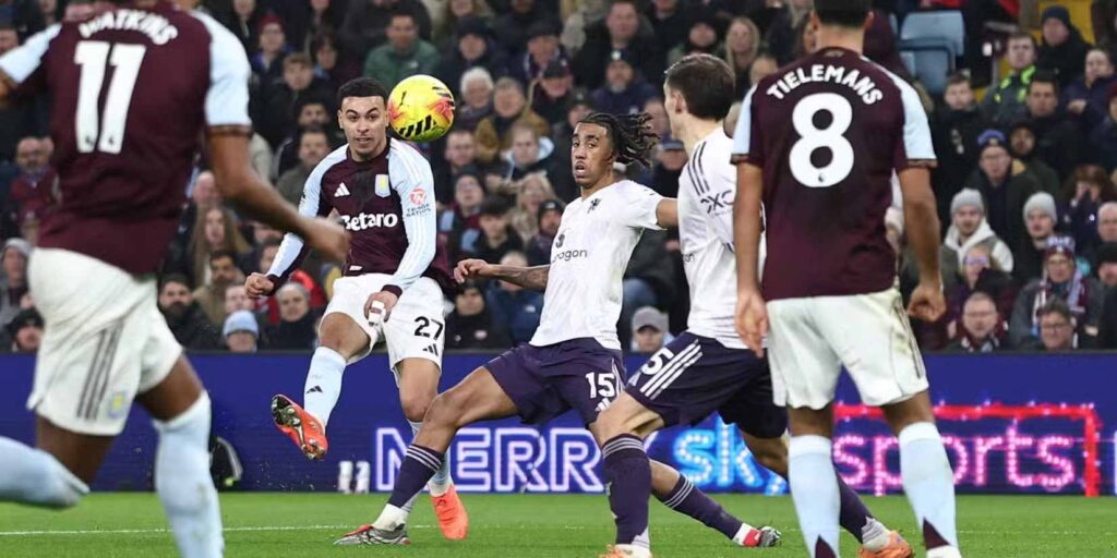 Morgan Rogers crosses the ball in the game against Manchester United