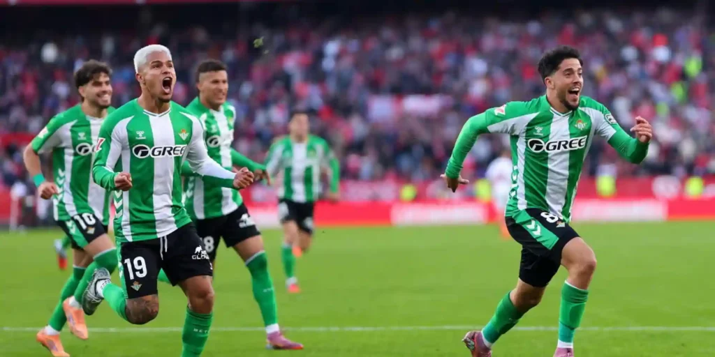 Betis players celebrate after scoring in the derby against Sevilla
